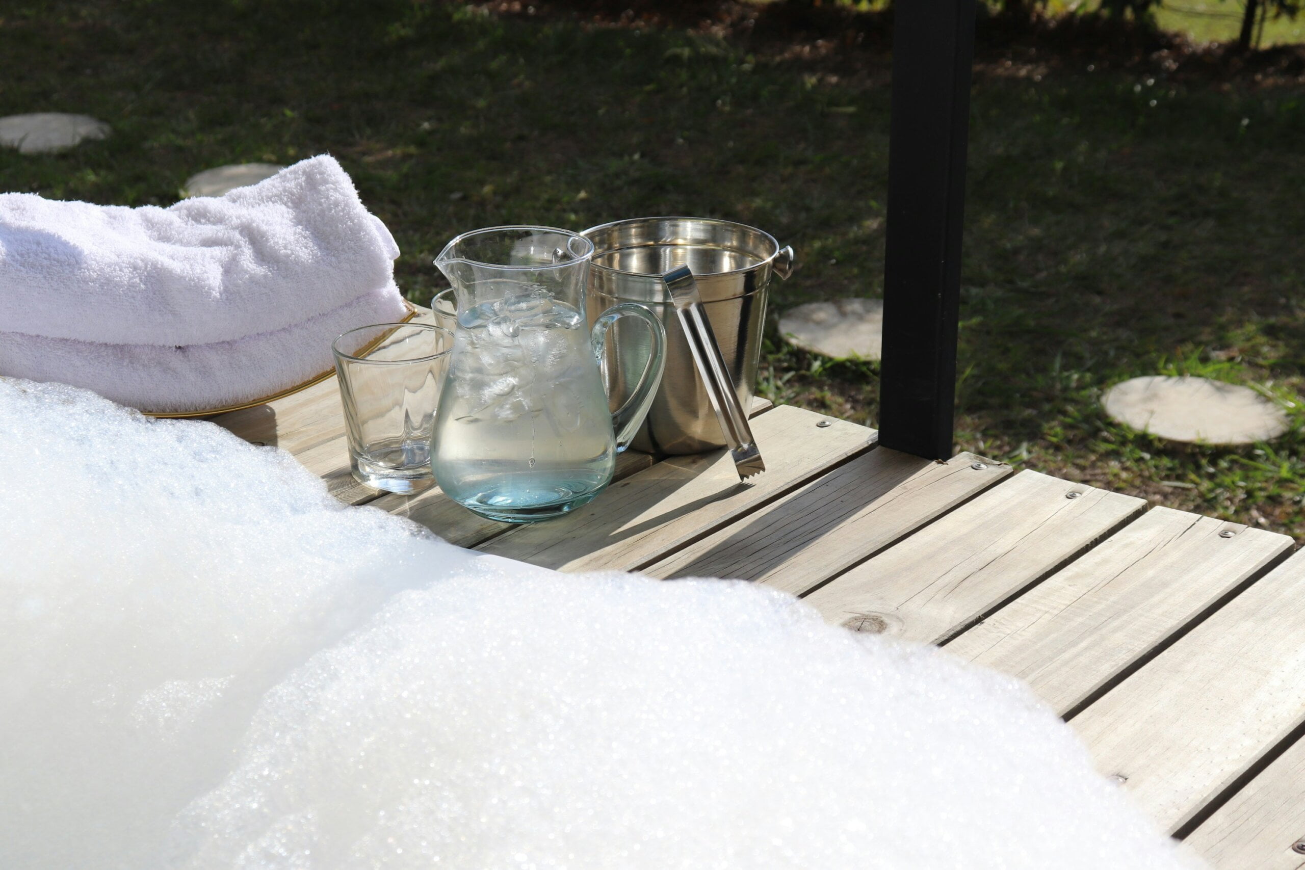 a pitcher of water sitting on top of a wooden table